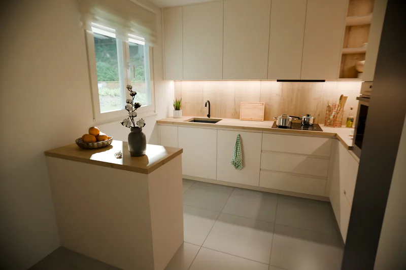 The small island ends in a plain worktop, with no bar or stools
